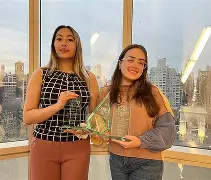 Champion debaters with tournament trophies